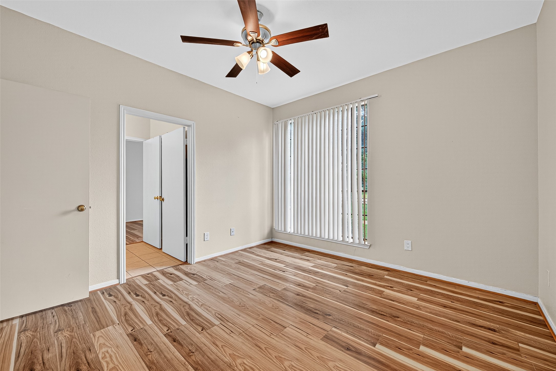 8055 Cambridge Street, Unit 89 Houston, TX 77054 - Photo 26 of 33 an empty room with wooden floor ceiling fan and windows