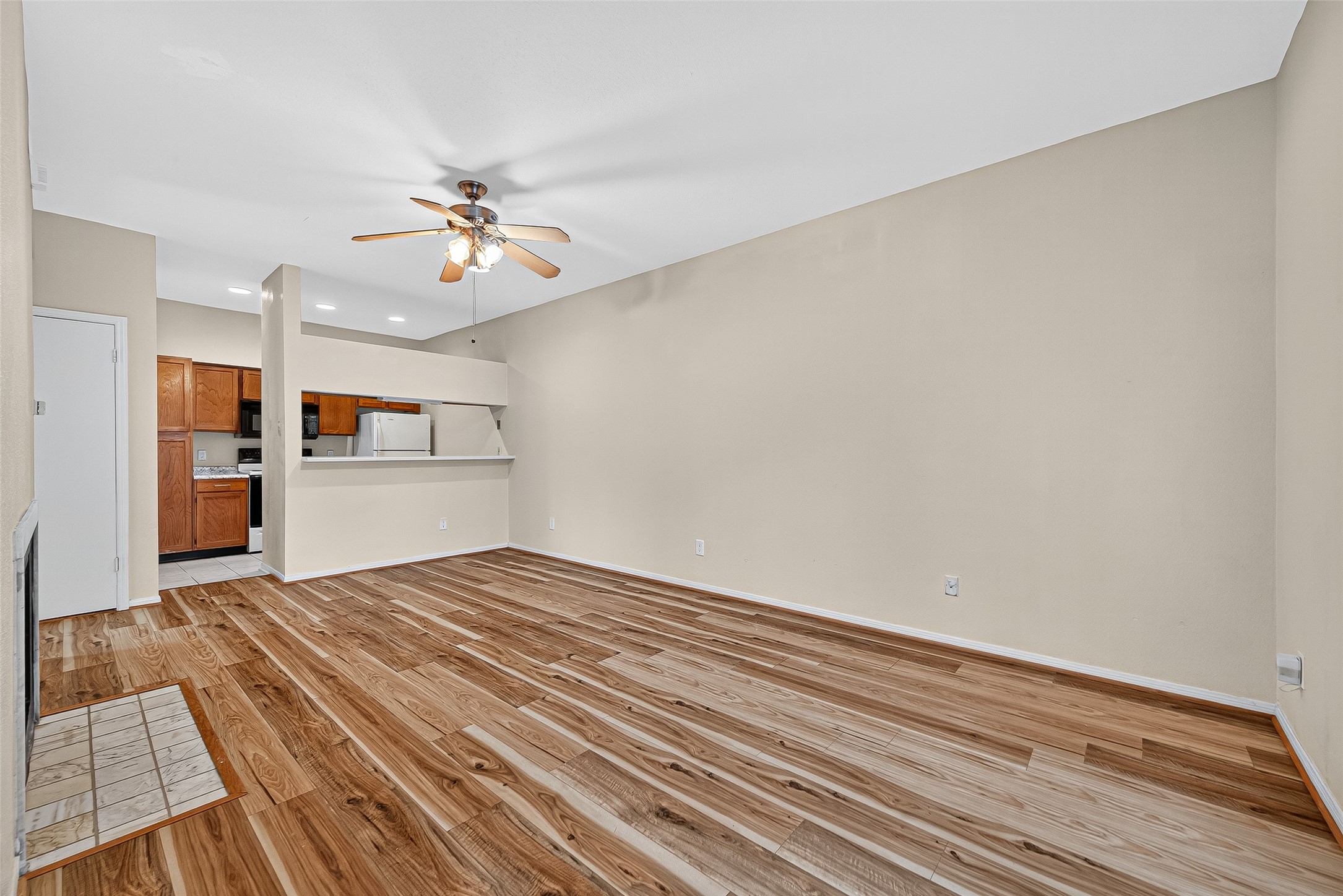 8055 Cambridge Street, Unit 89 Houston, TX 77054 - Photo 6 of 33 a view of empty room with wooden floor and kitchen view
