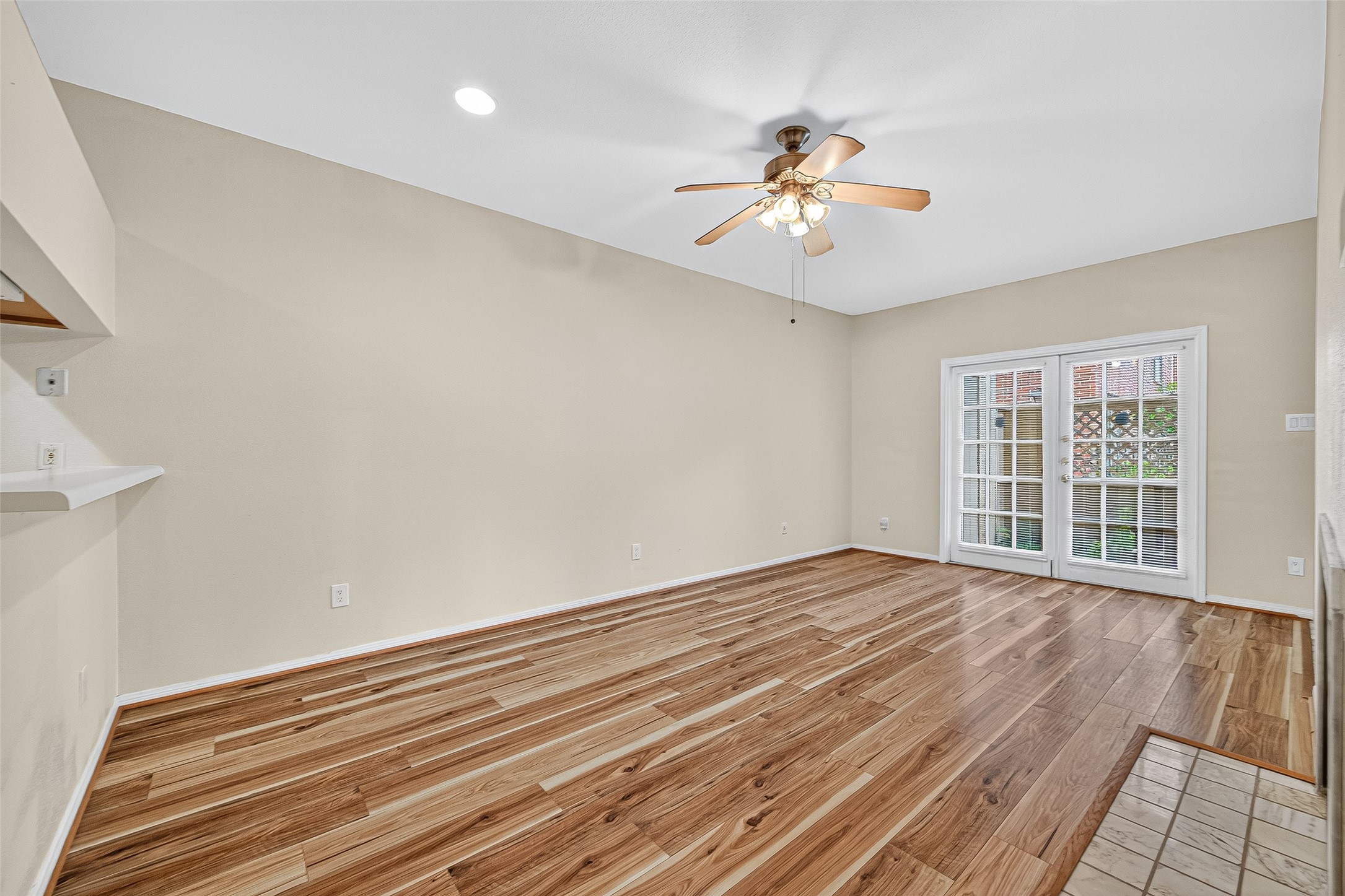 8055 Cambridge Street, Unit 89 Houston, TX 77054 - Photo 9 of 33 a view of an empty room with wooden floor and a window