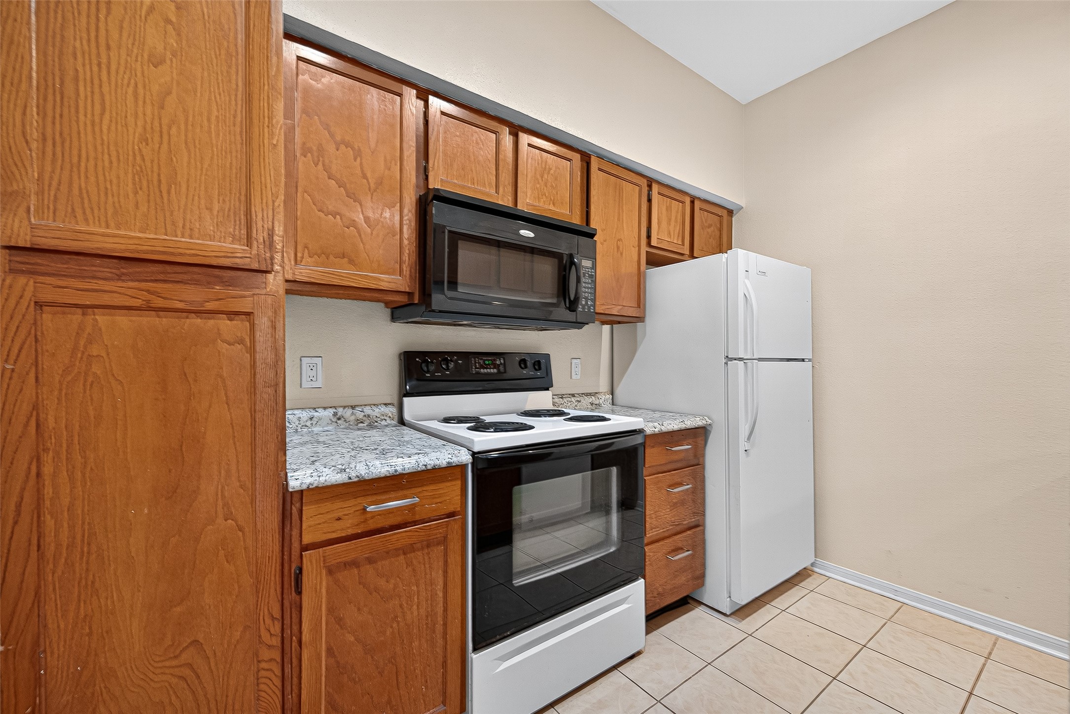 8055 Cambridge Street, Unit 89 Houston, TX 77054 - Photo 10 of 33 a kitchen with granite countertop cabinets stainless steel appliances and a window
