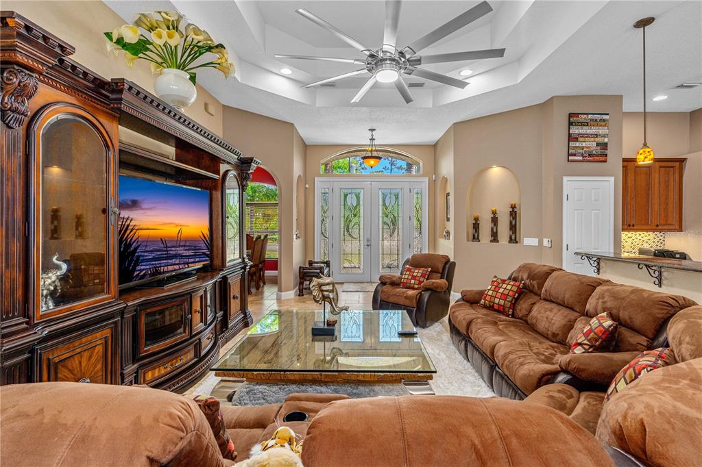 32 Seneca Path Palm Coast, FL 32164 - Photo 17 of 50 a living room with furniture a large window and a flat screen tv
