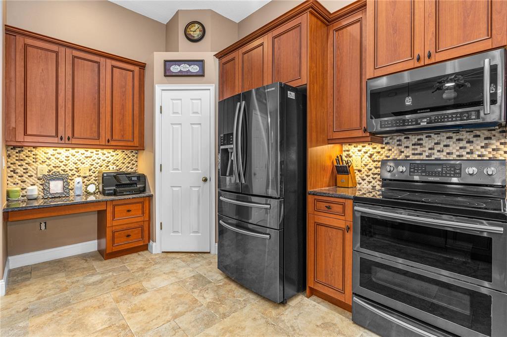 32 Seneca Path Palm Coast, FL 32164 - Photo 20 of 50 a kitchen with granite countertop a refrigerator stove and microwave