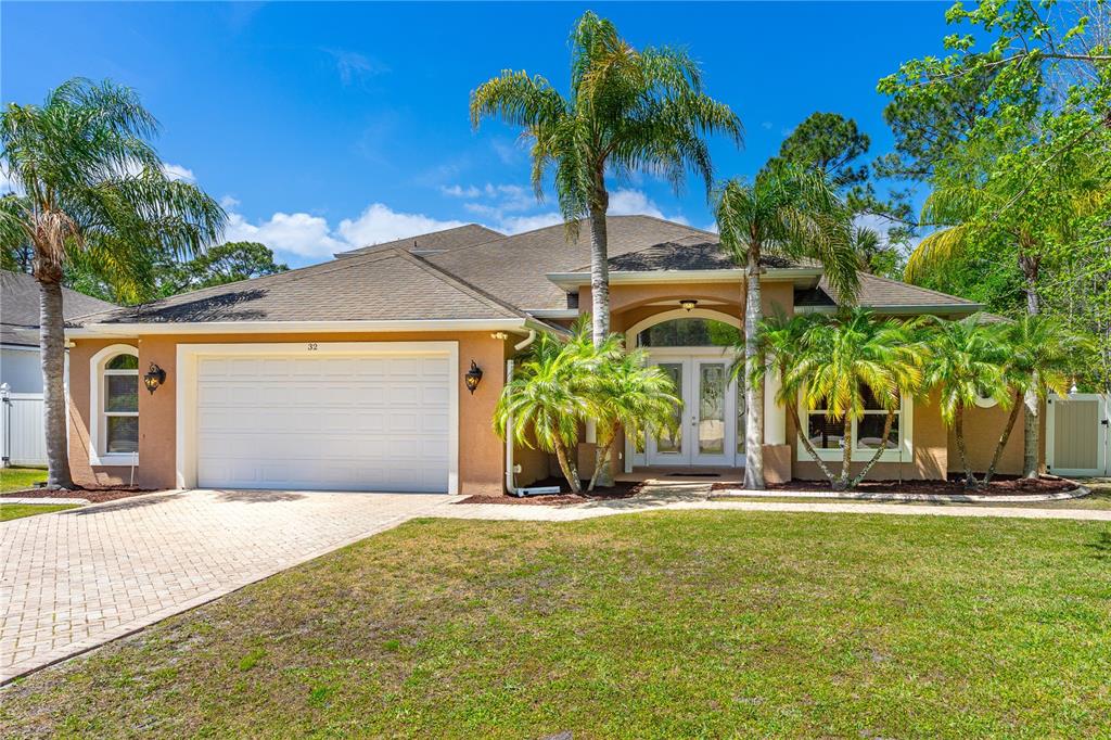 32 Seneca Path Palm Coast, FL 32164 - Photo 2 of 50 a front view of house with yard