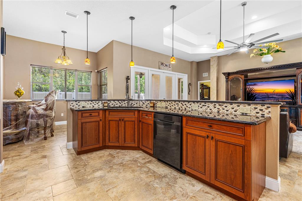 32 Seneca Path Palm Coast, FL 32164 - Photo 23 of 50 a large kitchen with kitchen island granite countertop a stove a sink and a wooden floor
