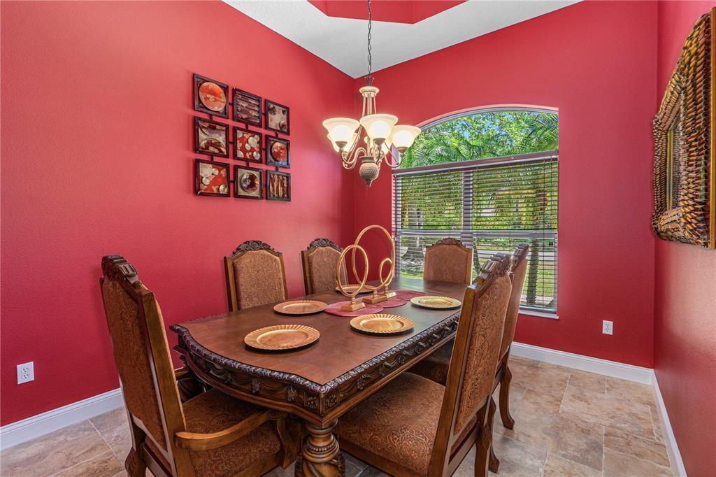 32 Seneca Path Palm Coast, FL 32164 - Photo 25 of 50 a view of a dining room with furniture a chandelier and large windows