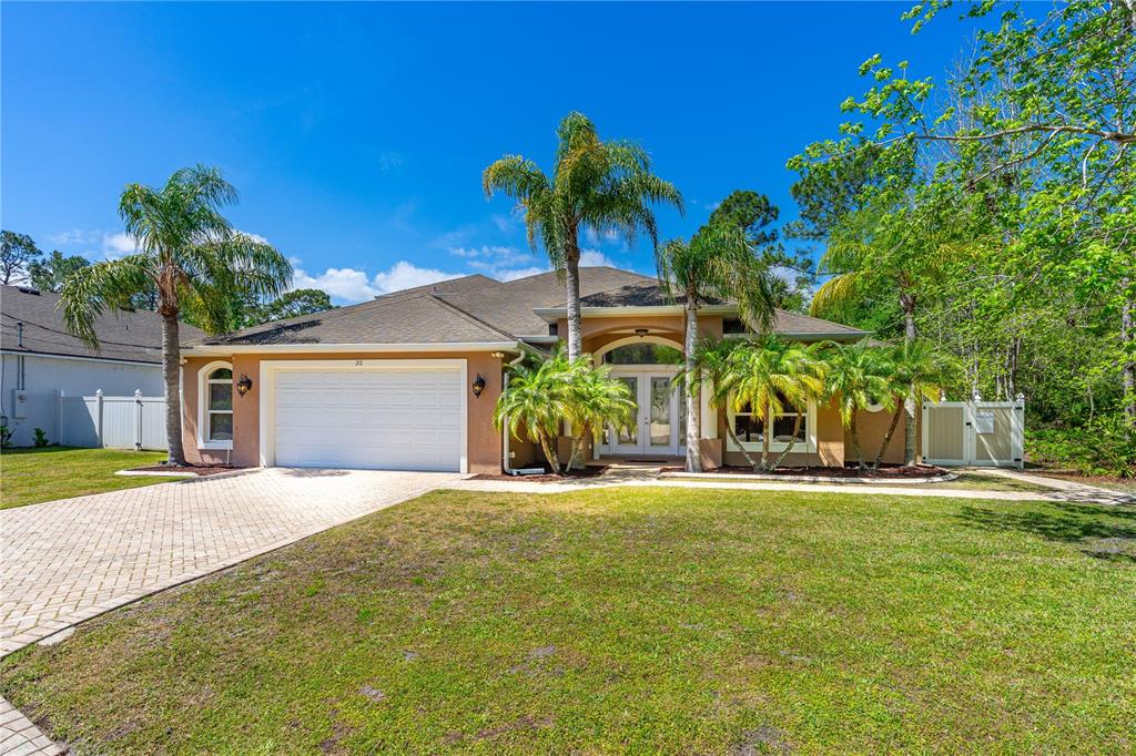 32 Seneca Path Palm Coast, FL 32164 - Photo 3 of 50 a front view of a house with a yard and garage