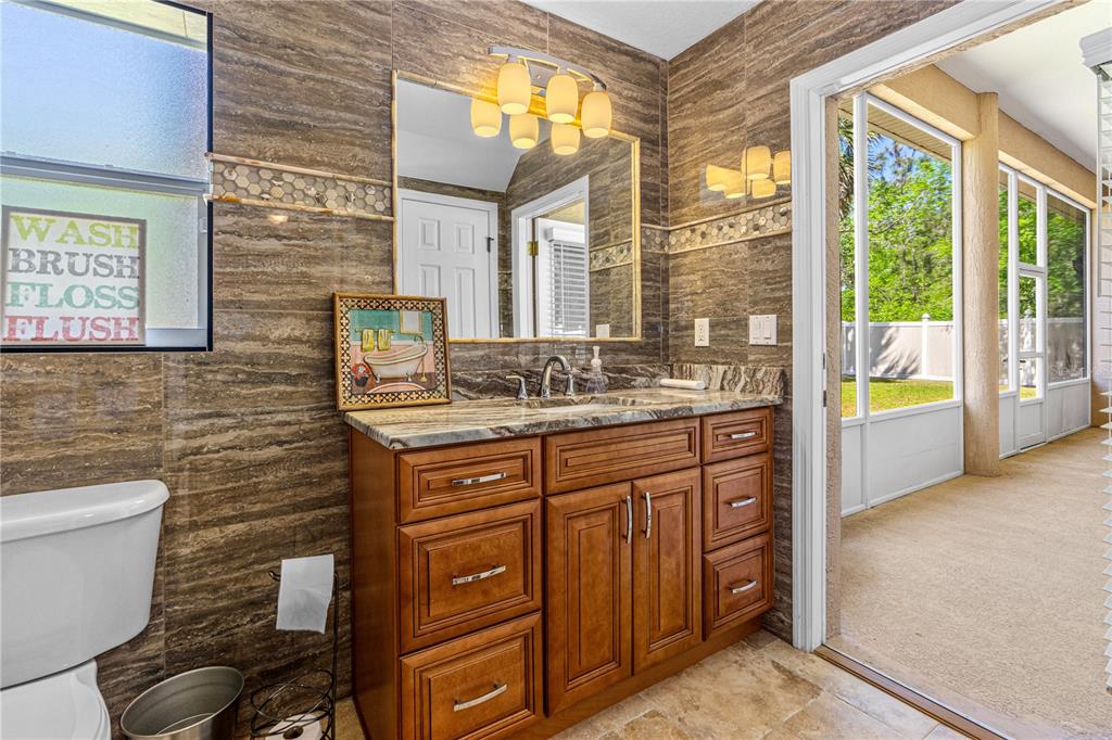 32 Seneca Path Palm Coast, FL 32164 - Photo 39 of 50 a bathroom with a granite countertop sink a toilet and a bathtub