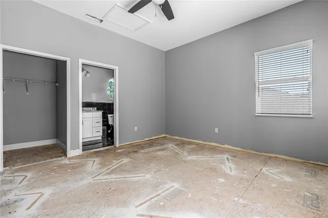 a view of a livingroom with a ceiling fan and window