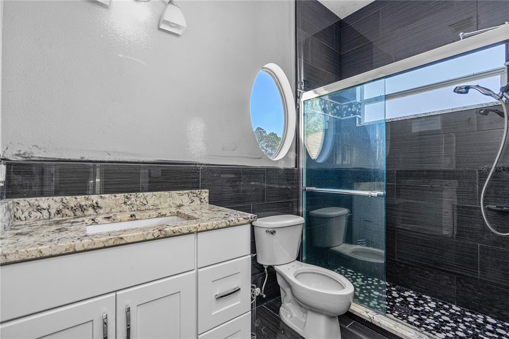 32 Seneca Path Palm Coast, FL 32164 - Photo 44 of 50 a bathroom with a sink toilet and shower