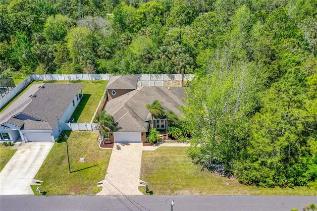 an aerial view of a house with a swimming pool