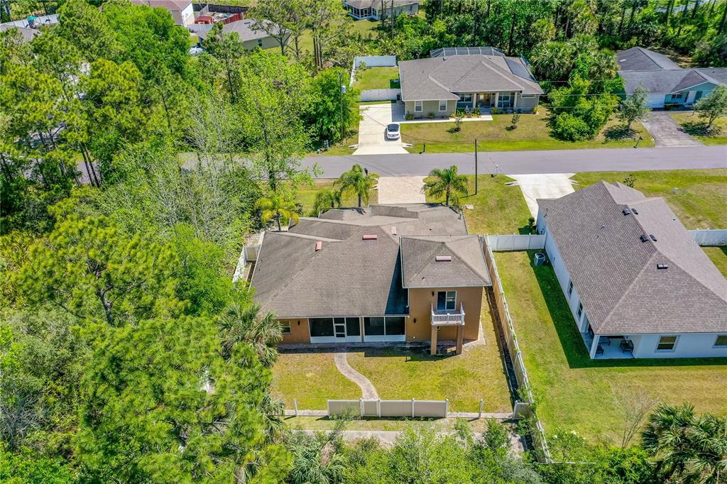 32 Seneca Path Palm Coast, FL 32164 - Photo 48 of 50 an aerial view of a house with swimming pool and large trees