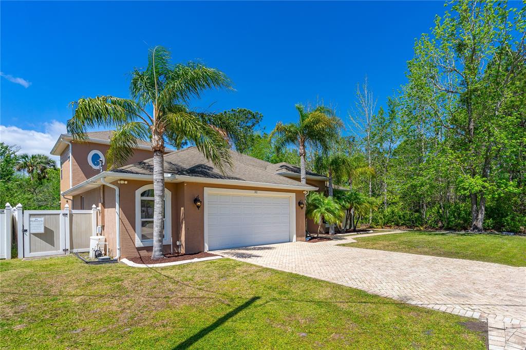 32 Seneca Path Palm Coast, FL 32164 - Photo 5 of 50 a front view of a house with a yard and garage