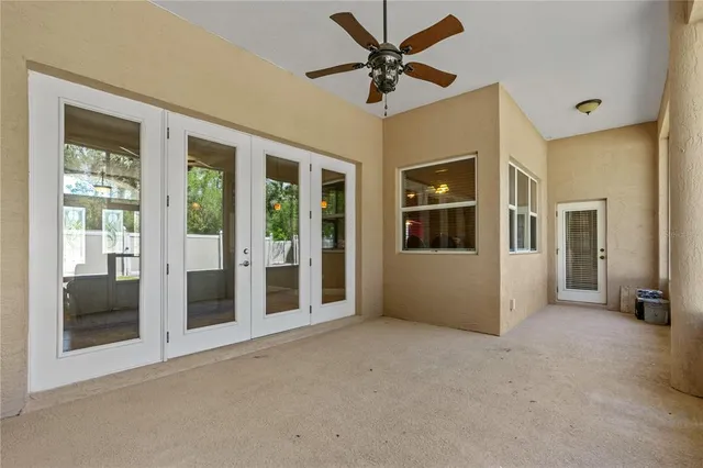 a view of a big room with wooden floor and windows