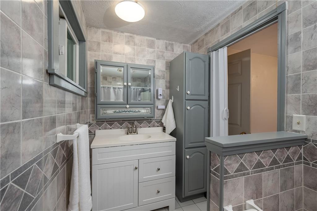 114 Weitzel Road Butler, PA 16002 - Photo 16 of 25 a bathroom with a sink and a mirror