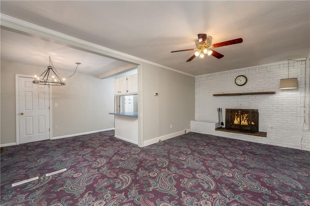 114 Weitzel Road Butler, PA 16002 - Photo 3 of 25 a view of an empty room with chandelier fan and fireplace
