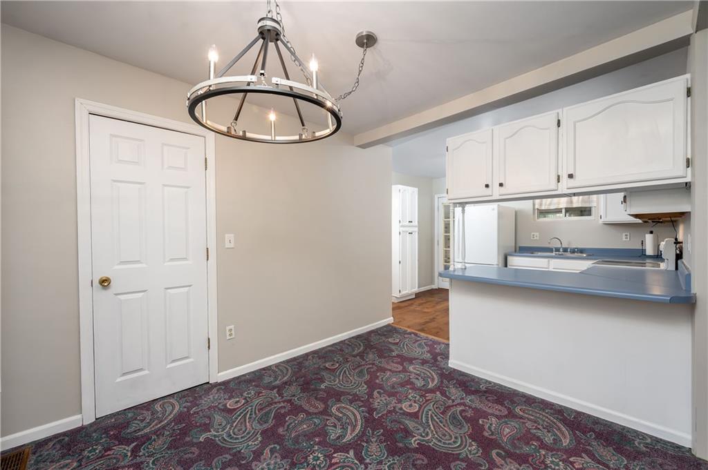 114 Weitzel Road Butler, PA 16002 - Photo 6 of 25 a view of a kitchen with wooden floor and white cabinets