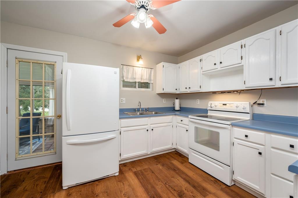 114 Weitzel Road Butler, PA 16002 - Photo 7 of 25 a kitchen with granite countertop white cabinets and white appliances