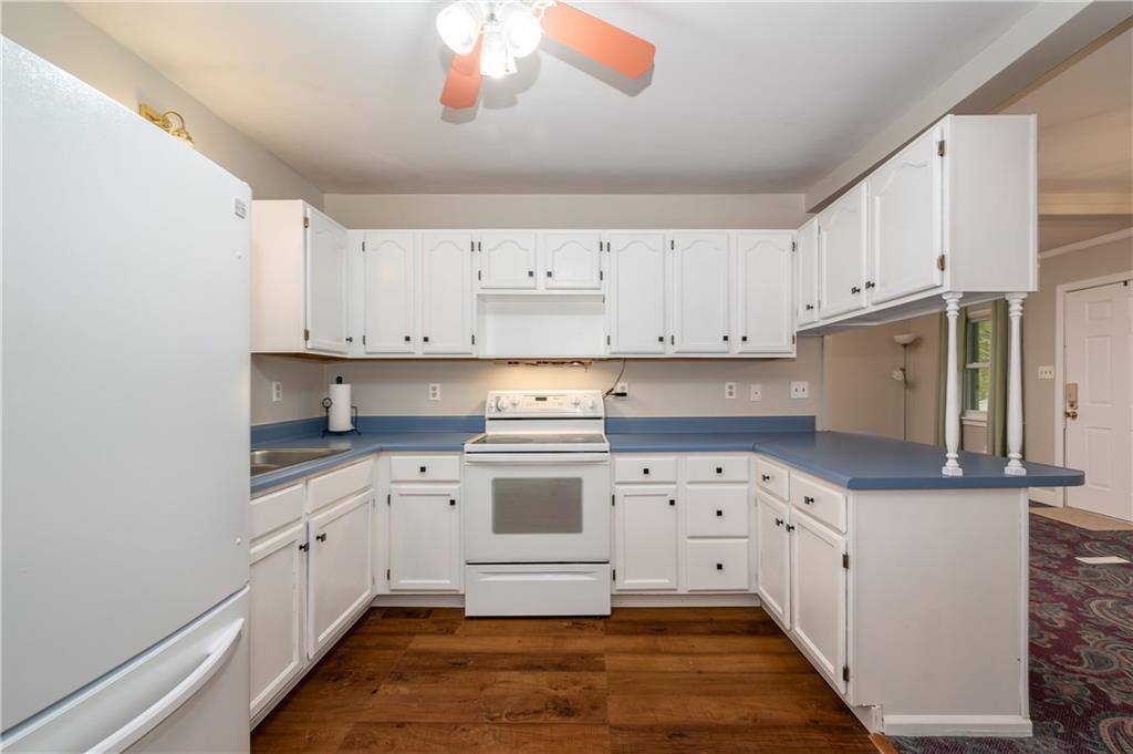 114 Weitzel Road Butler, PA 16002 - Photo 8 of 25 a kitchen with granite countertop a white stove top oven and white cabinets
