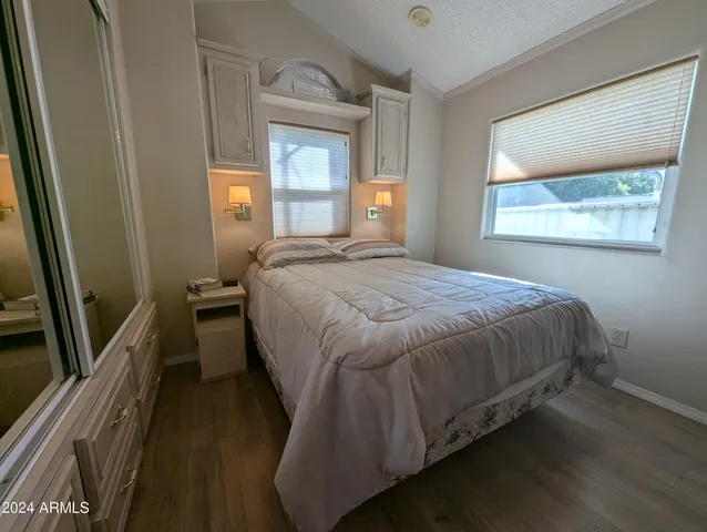a bedroom with a bed and a large mirror