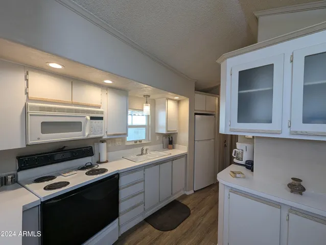a kitchen with a sink stove and microwave