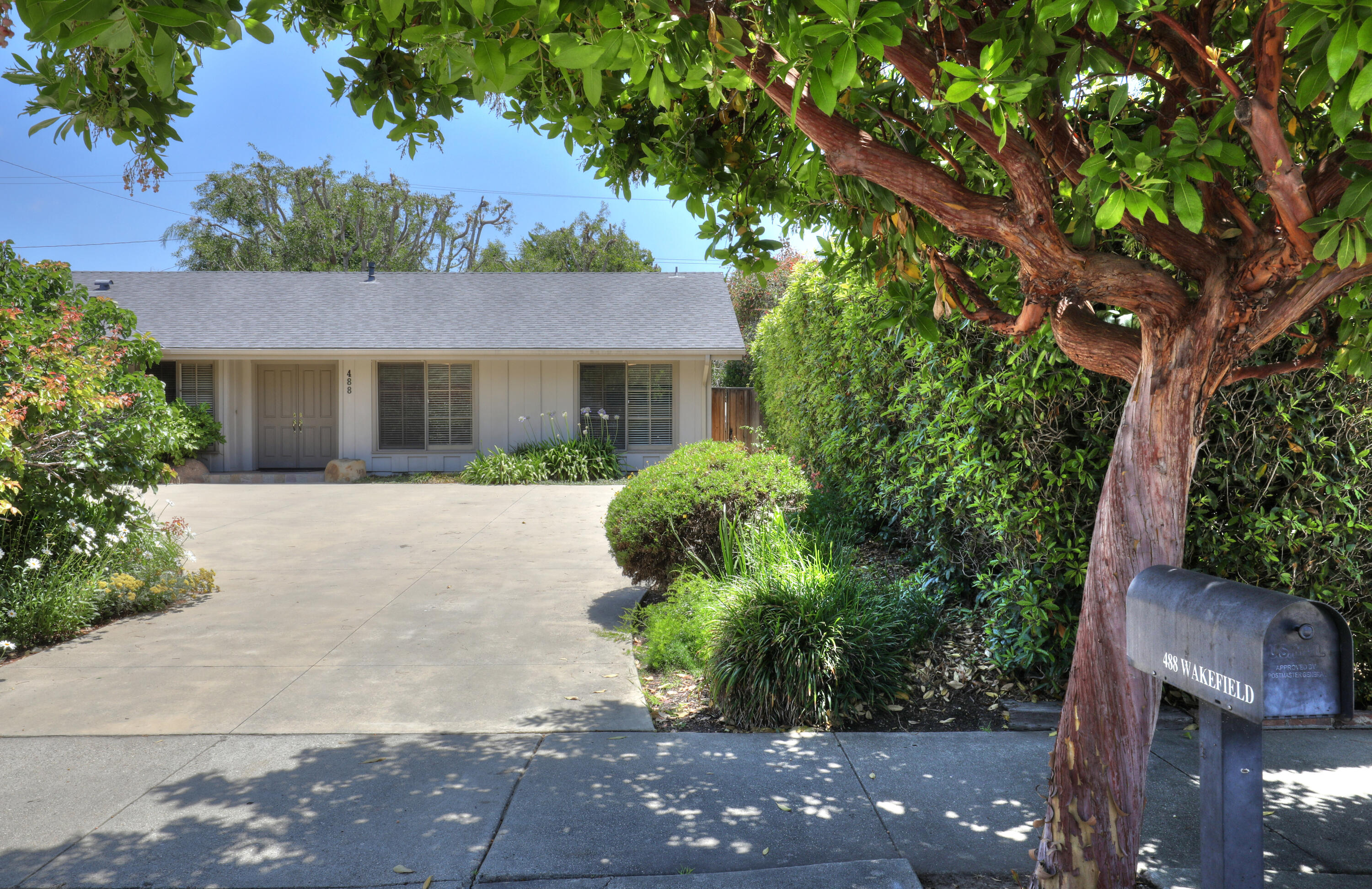 front view of a house with a tree