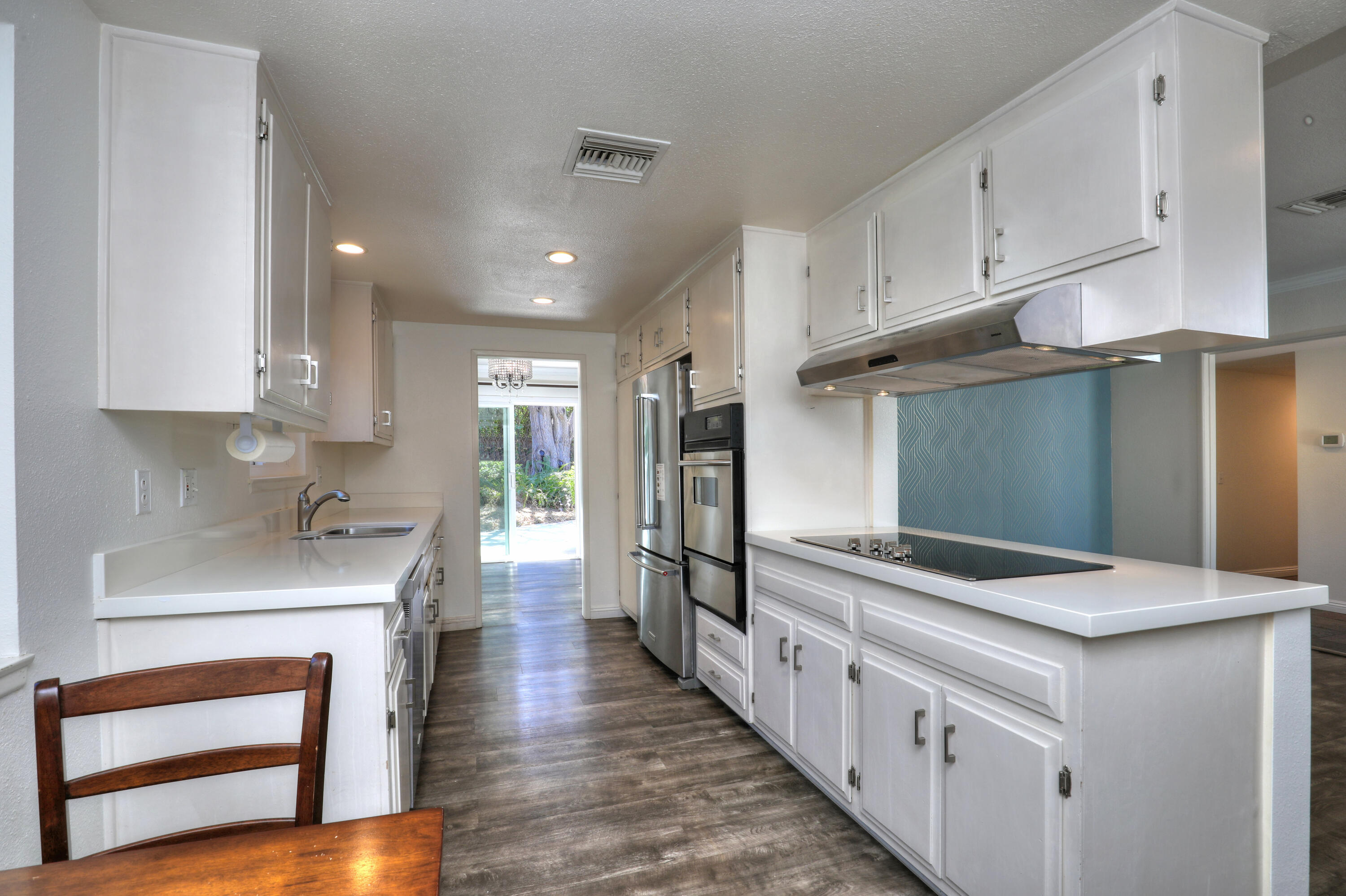 488 Wakefield Road Goleta, CA 93117 - Photo 11 of 34 a kitchen with stainless steel appliances granite countertop a lot of counter space and wooden floors