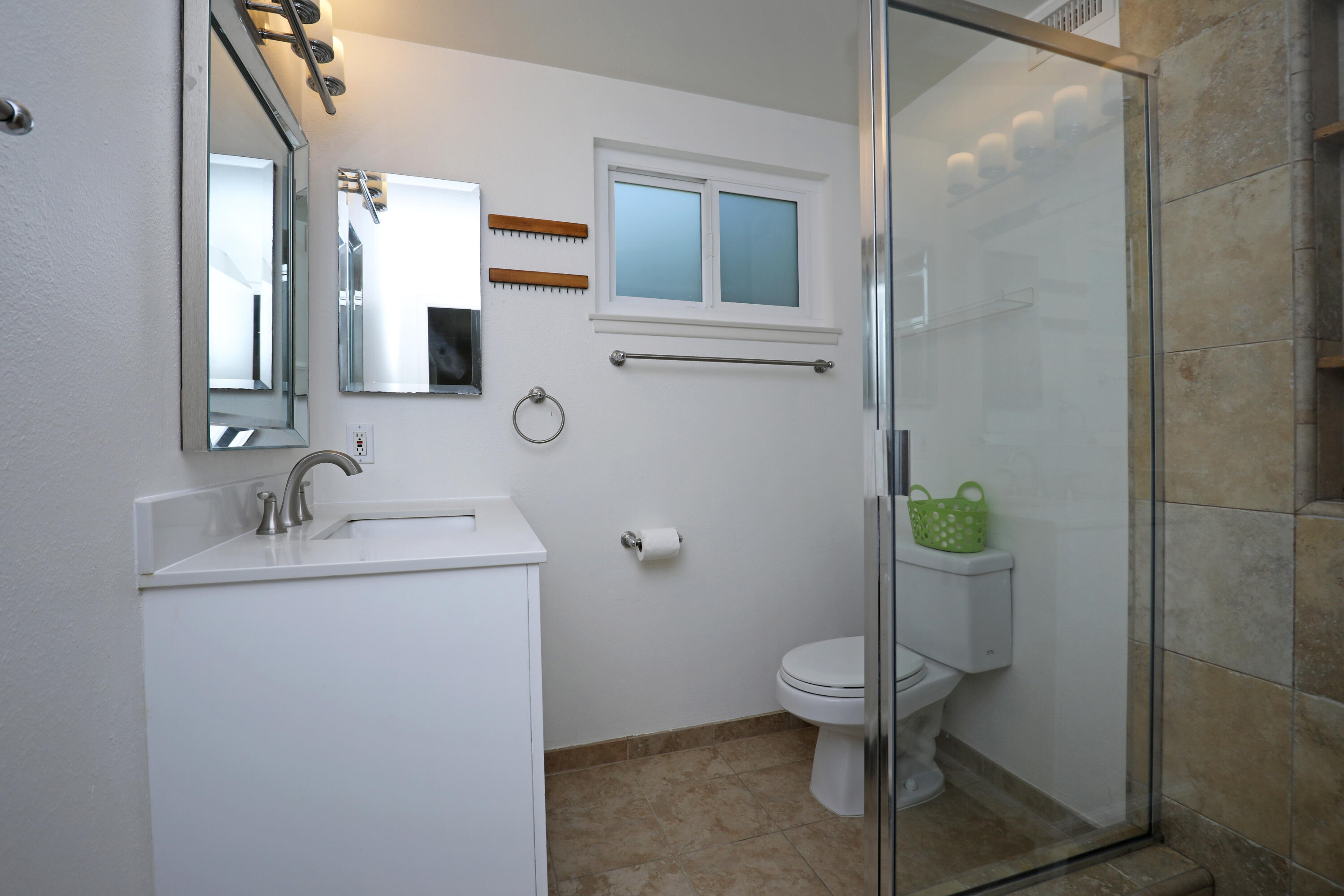 488 Wakefield Road Goleta, CA 93117 - Photo 21 of 34 a bathroom with a granite countertop toilet sink and mirror