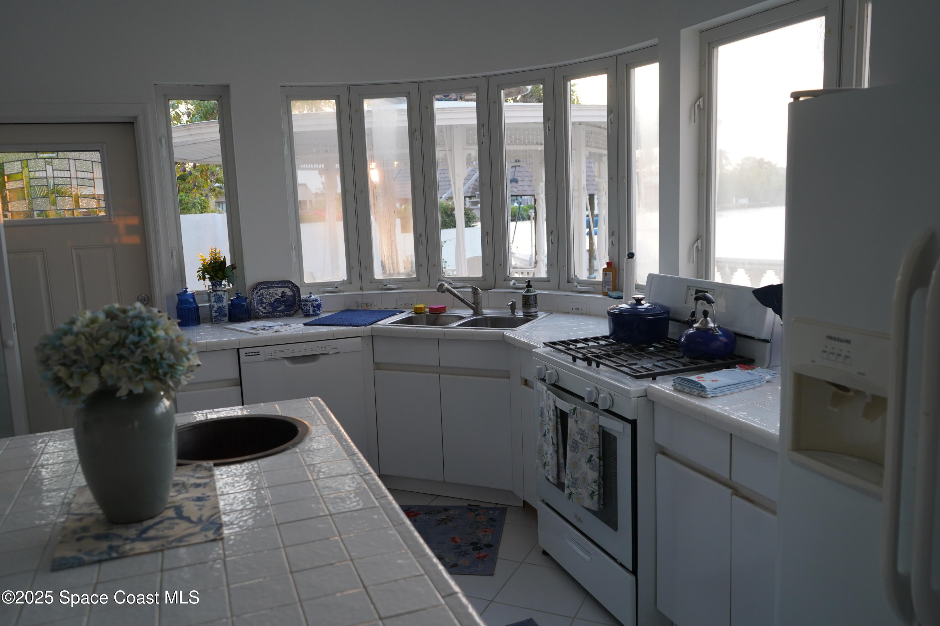 345 South Point Court Satellite Beach, FL 32937 - Photo 12 of 27 a kitchen with a sink stove and cabinets