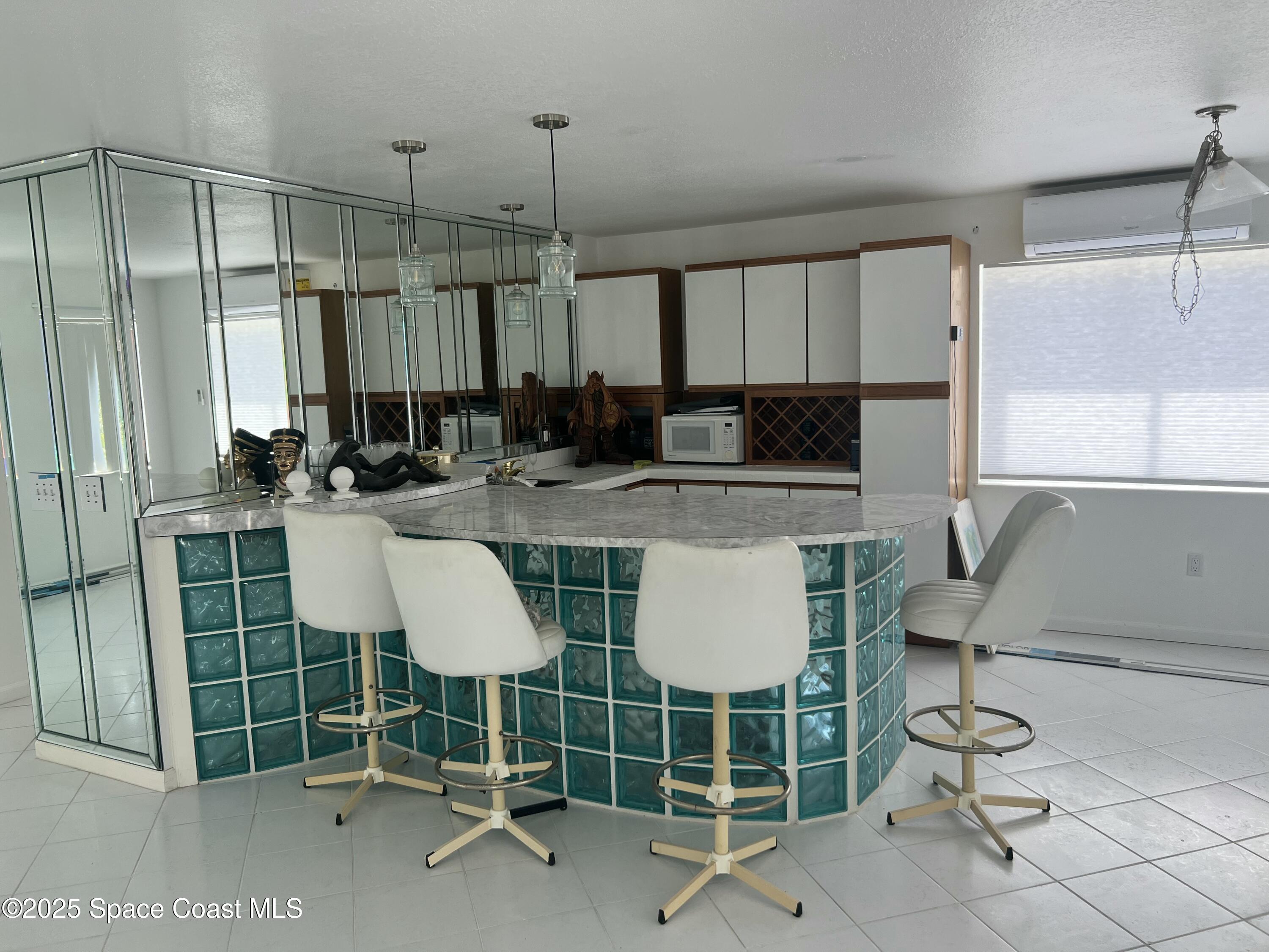 345 South Point Court Satellite Beach, FL 32937 - Photo 14 of 27 a kitchen with stainless steel appliances a stove a sink and a refrigerator