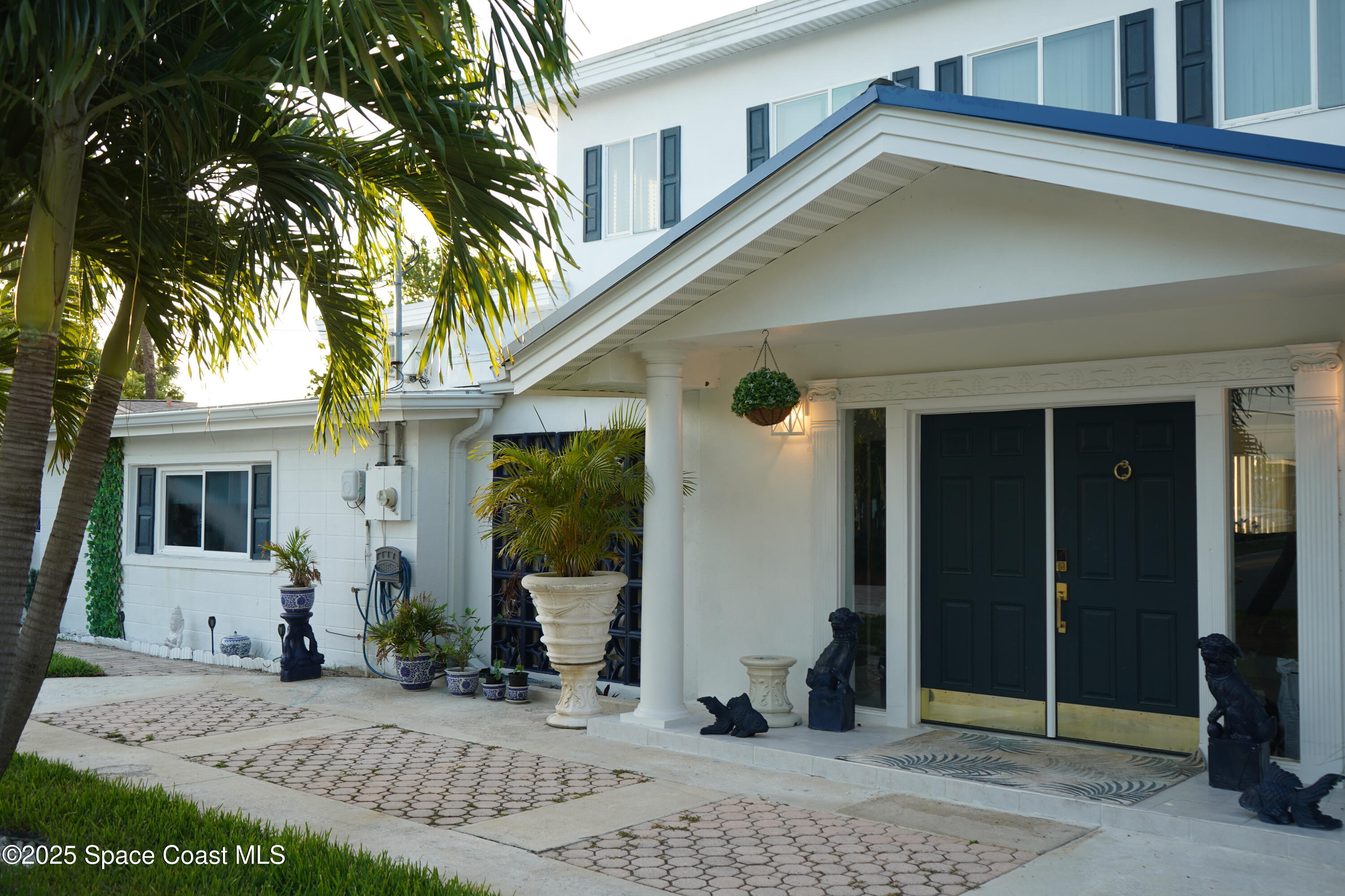 345 South Point Court Satellite Beach, FL 32937 - Photo 3 of 27 a front view of a house with garden