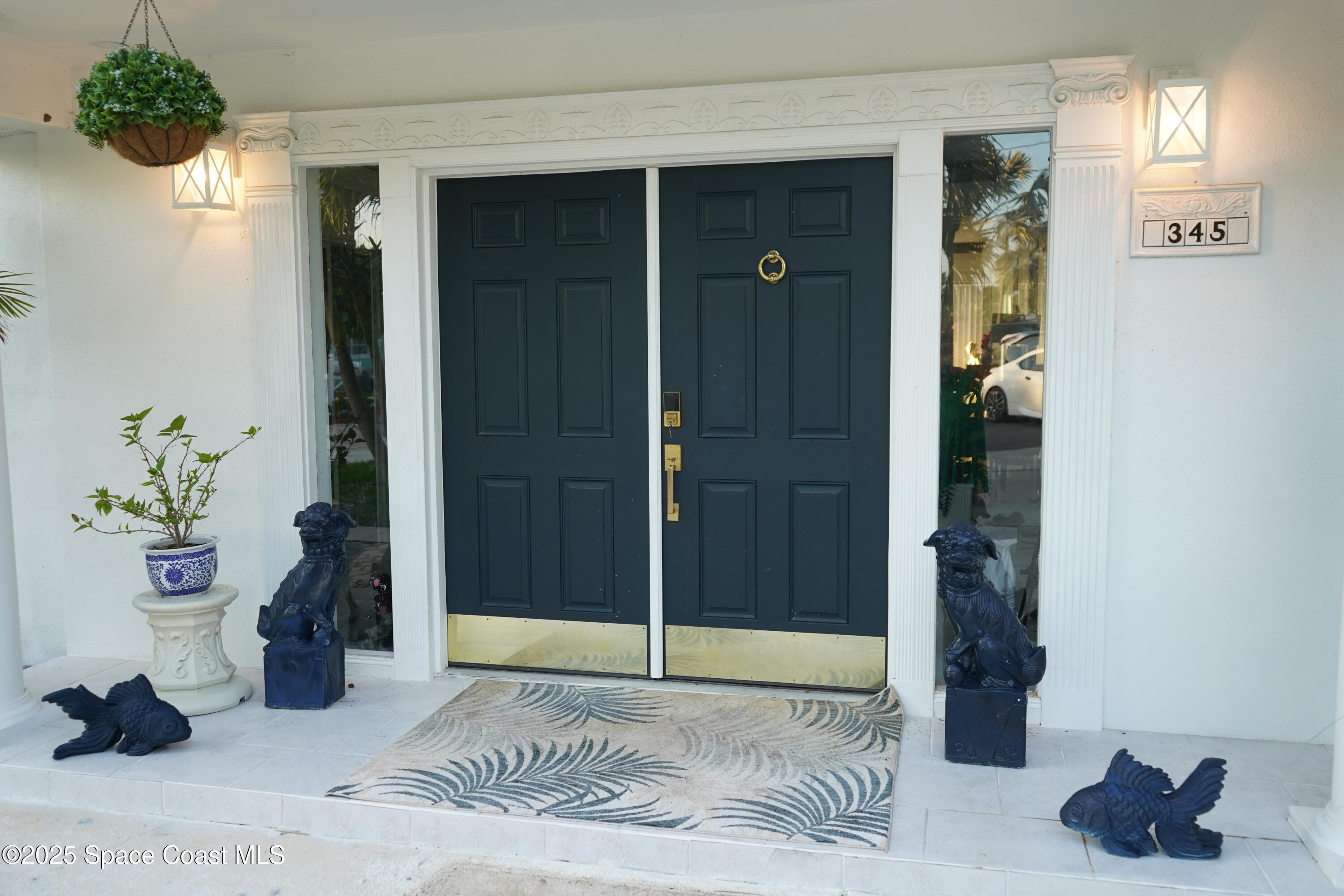 345 South Point Court Satellite Beach, FL 32937 - Photo 4 of 27 a view of an entryway with a flower pot