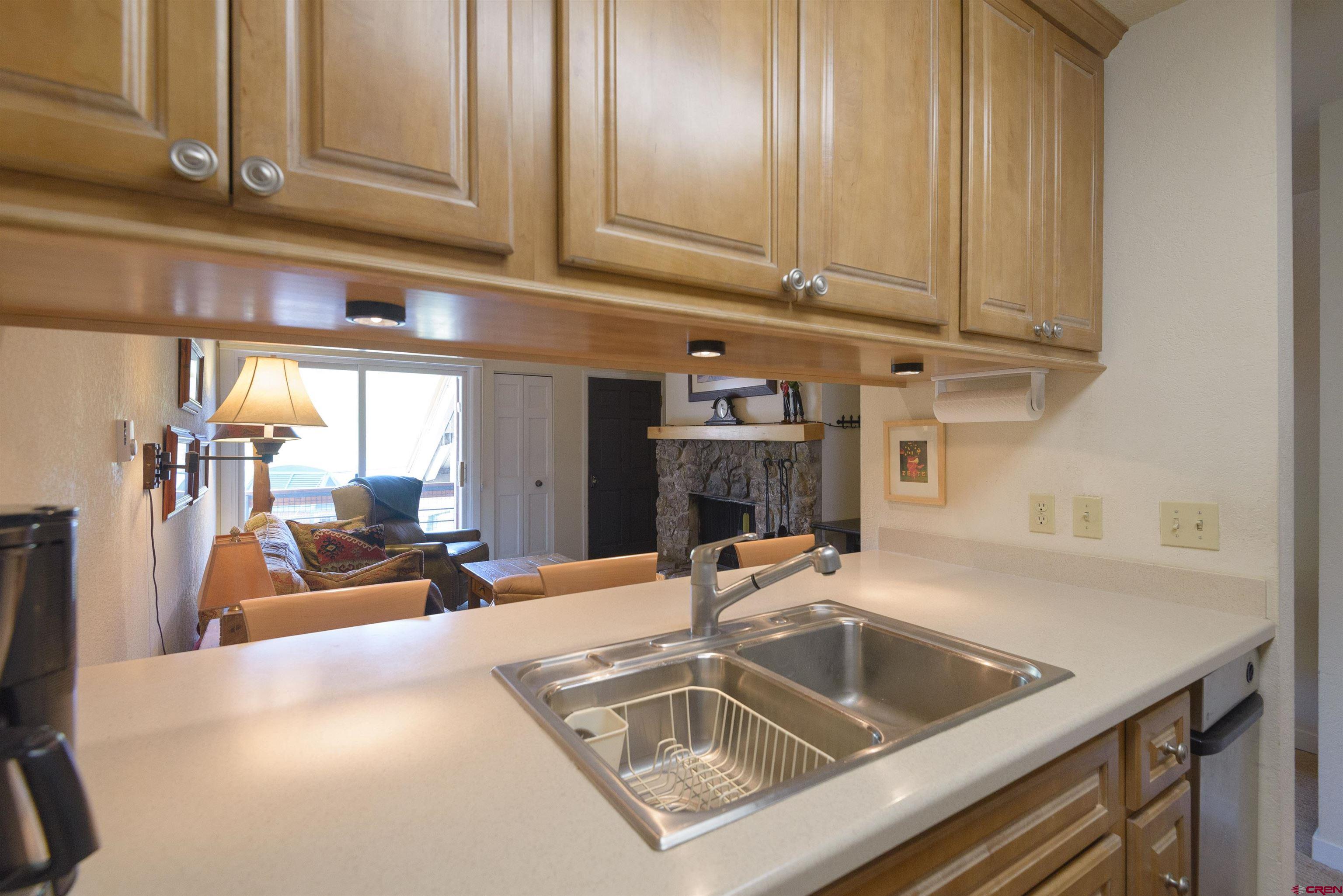 12 Snowmass Road, Unit 416 Crested Butte, CO 81225 - Photo 12 of 35 a kitchen with a sink and cabinets