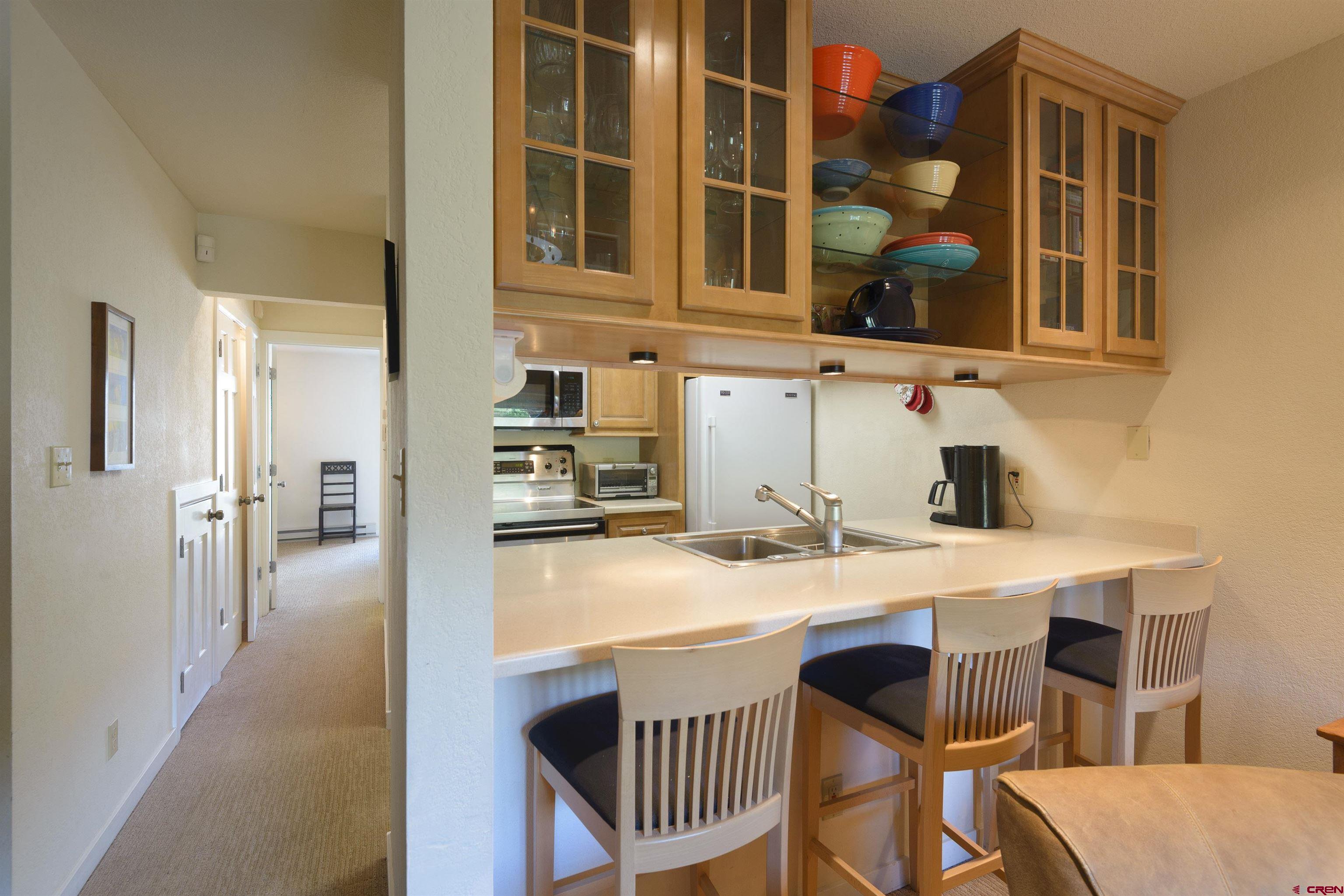 12 Snowmass Road, Unit 416 Crested Butte, CO 81225 - Photo 13 of 35 a kitchen with a sink cabinets and wooden floor