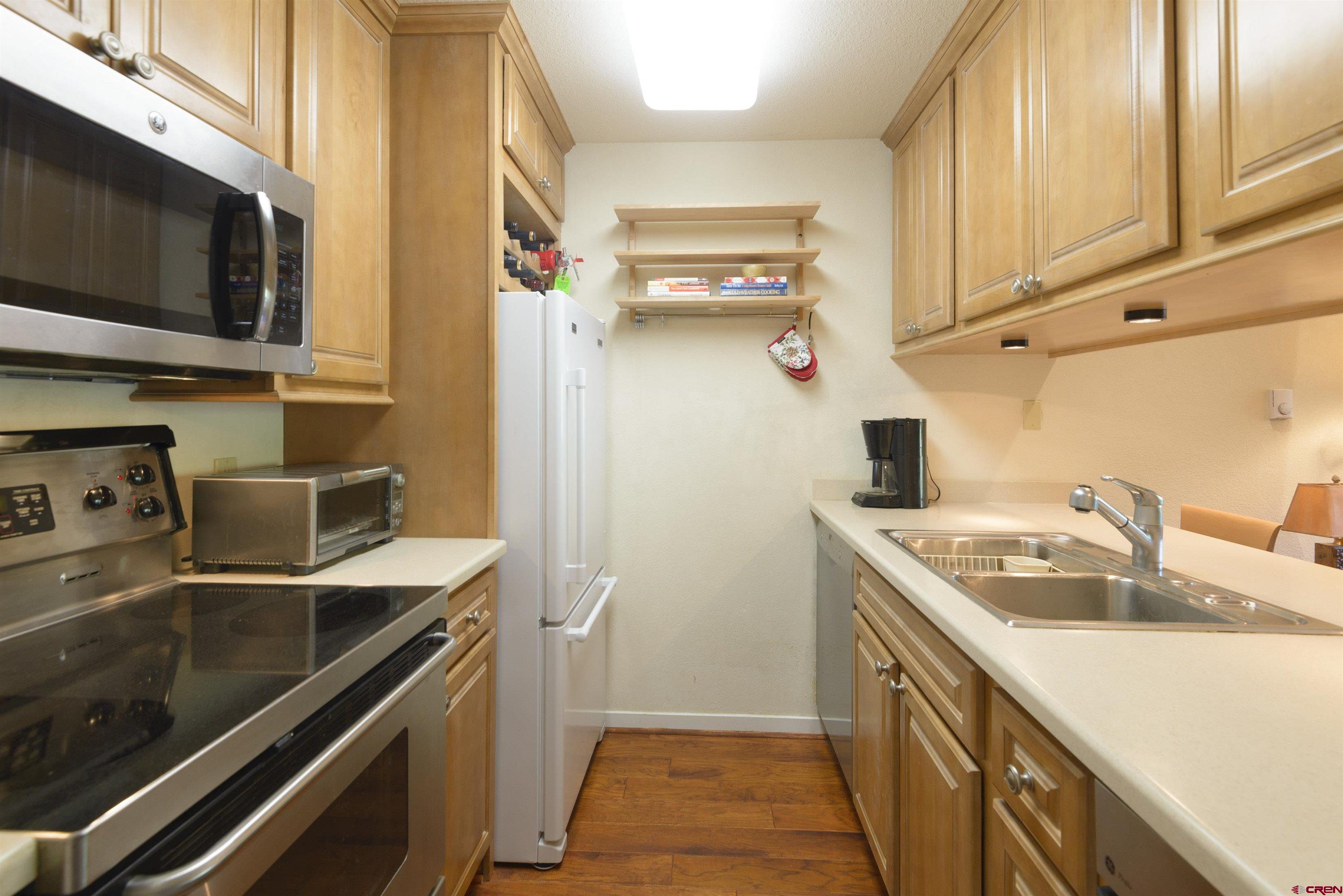 12 Snowmass Road, Unit 416 Crested Butte, CO 81225 - Photo 15 of 35 a kitchen with a sink and steel appliances