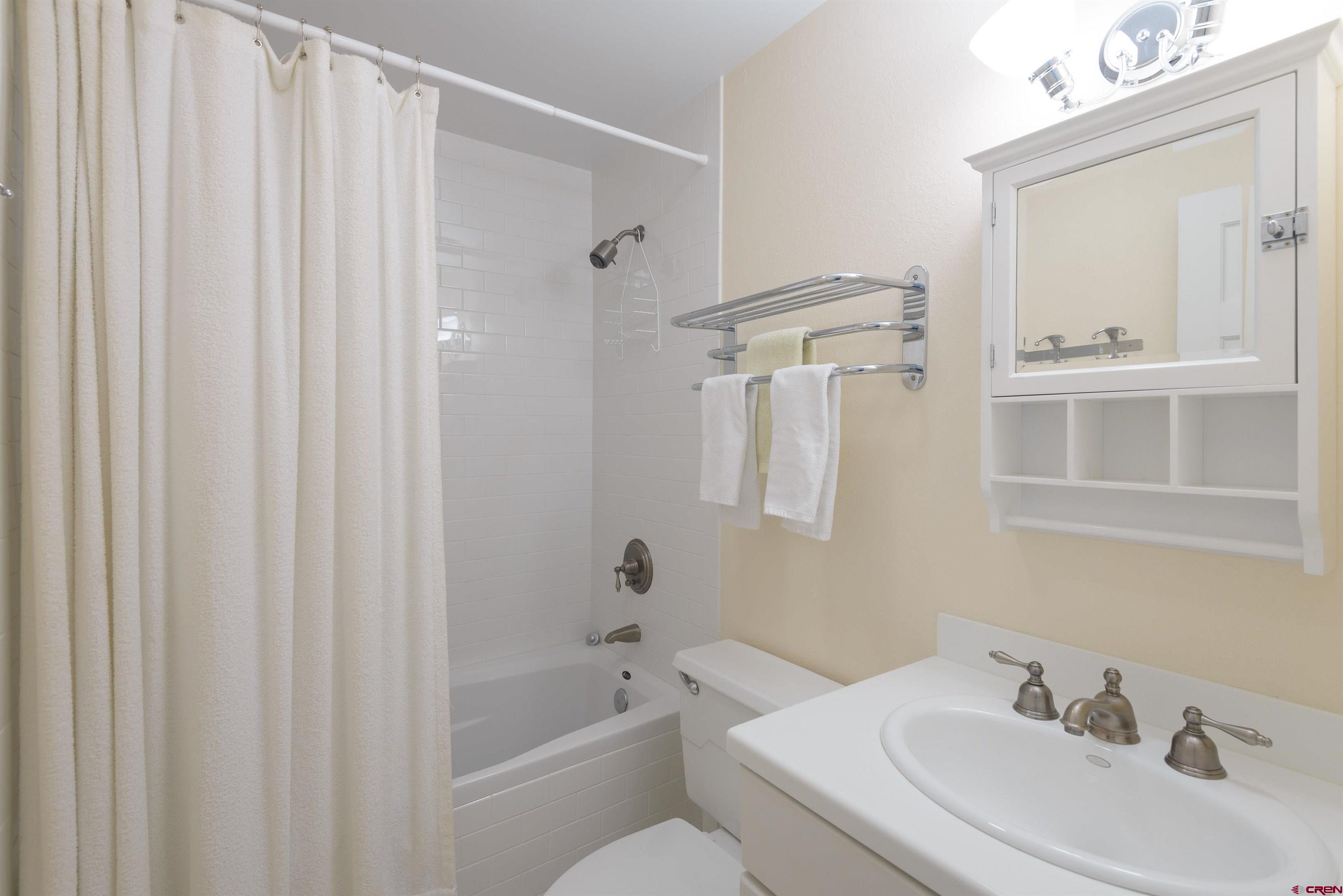 12 Snowmass Road, Unit 416 Crested Butte, CO 81225 - Photo 20 of 35 a bathroom with a sink a toilet and shower