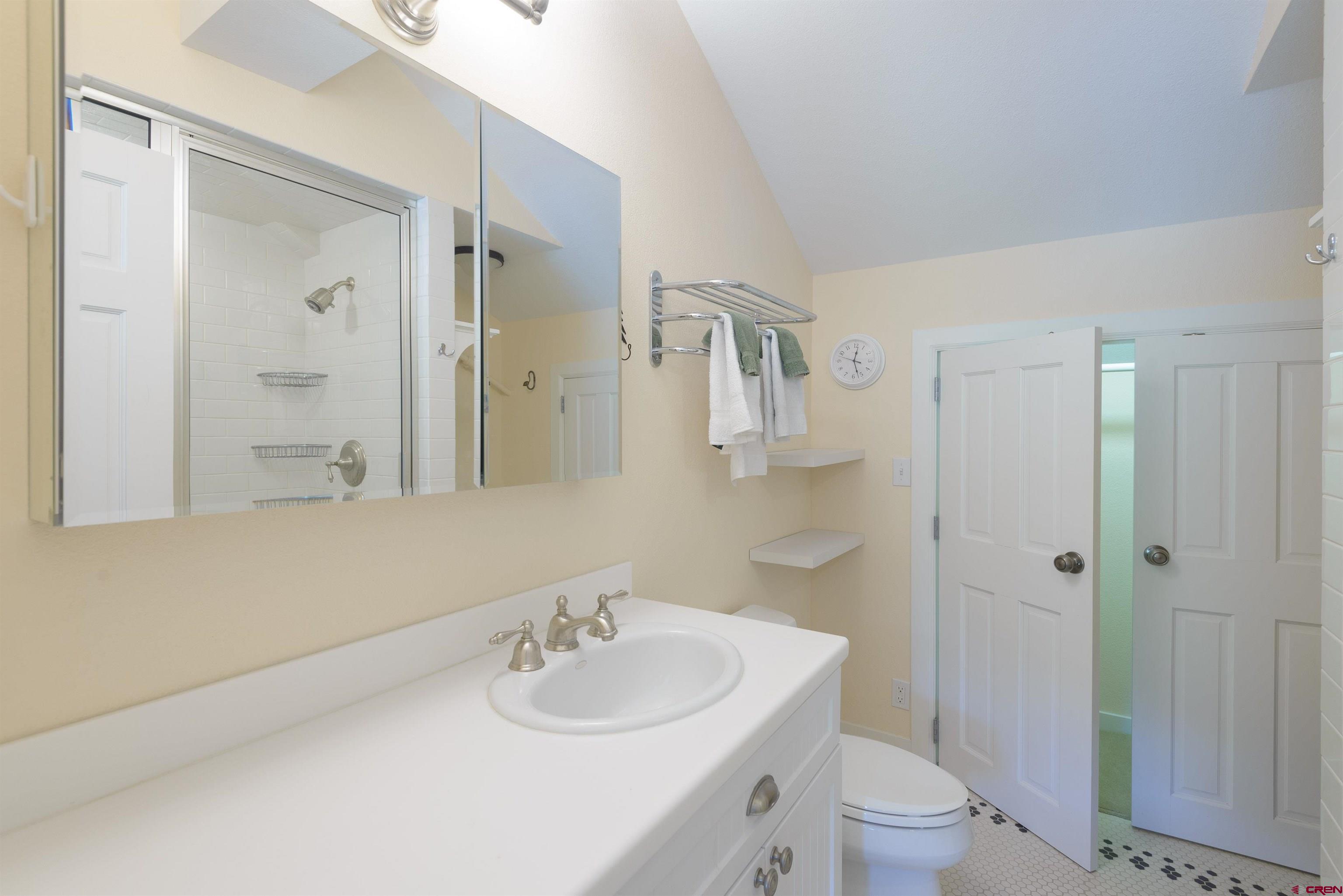 12 Snowmass Road, Unit 416 Crested Butte, CO 81225 - Photo 21 of 35 a bathroom with a sink toilet a mirror and shower