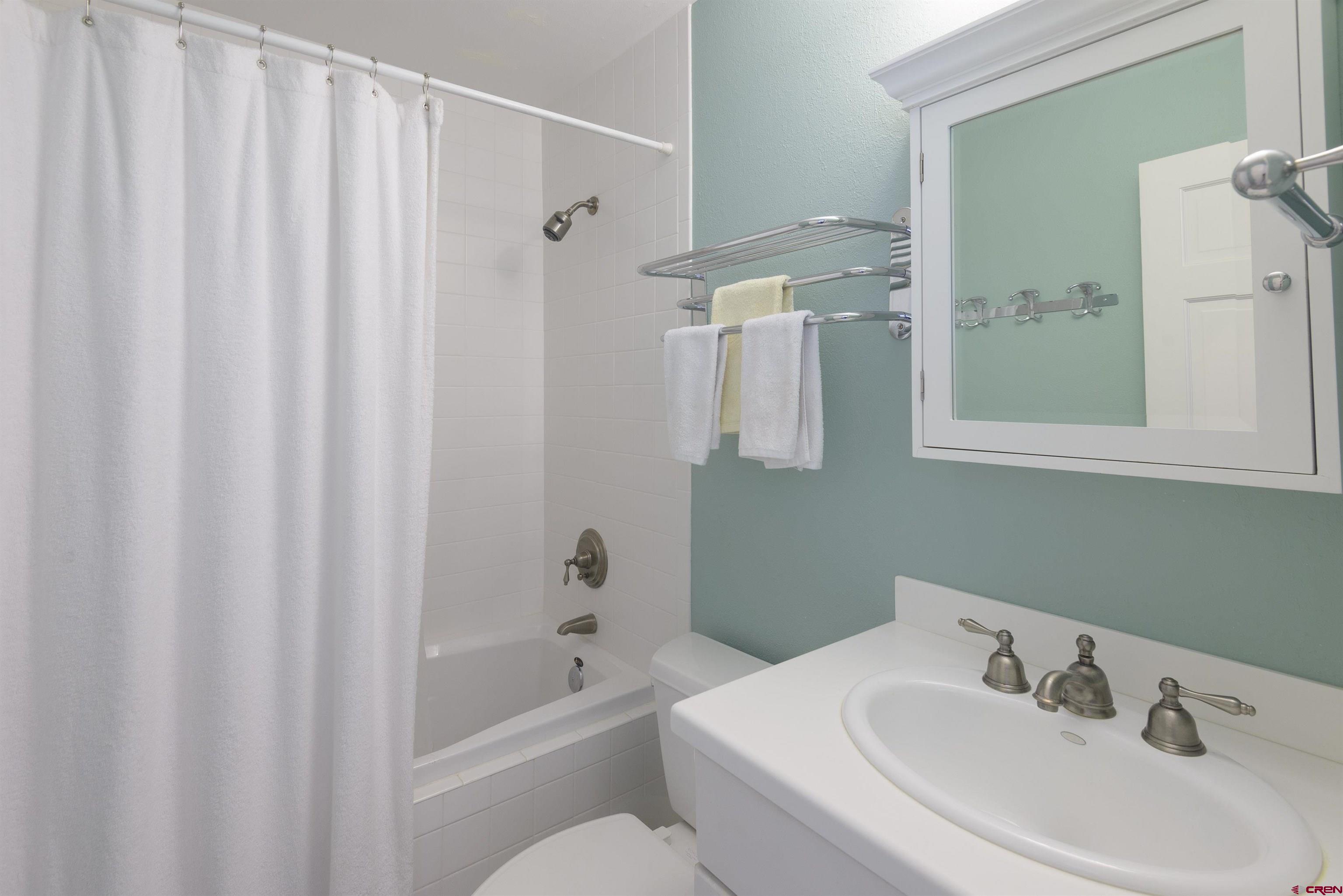 12 Snowmass Road, Unit 416 Crested Butte, CO 81225 - Photo 28 of 35 a bathroom with a sink a toilet and shower