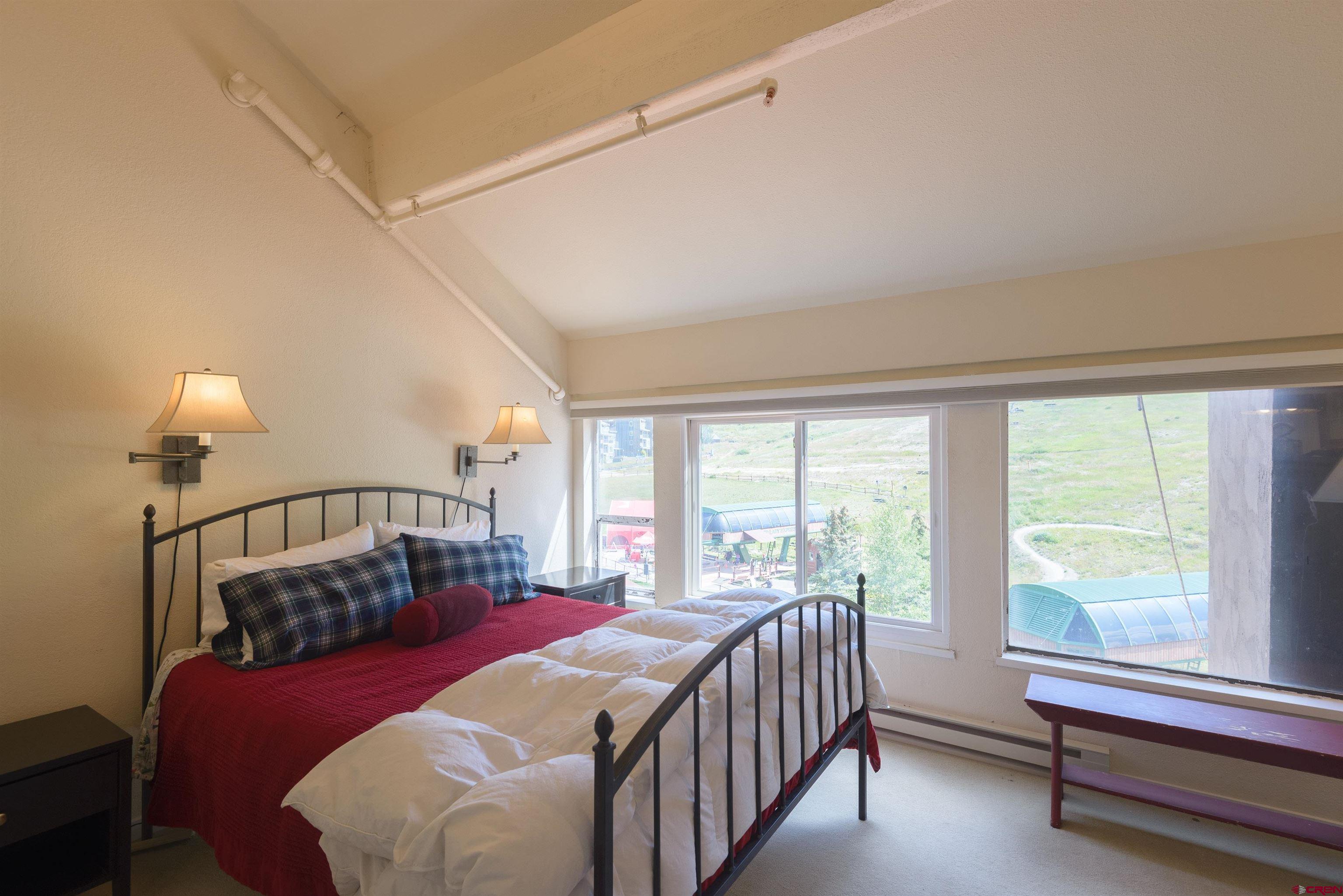 12 Snowmass Road, Unit 416 Crested Butte, CO 81225 - Photo 29 of 35 a bedroom with a bed and a window