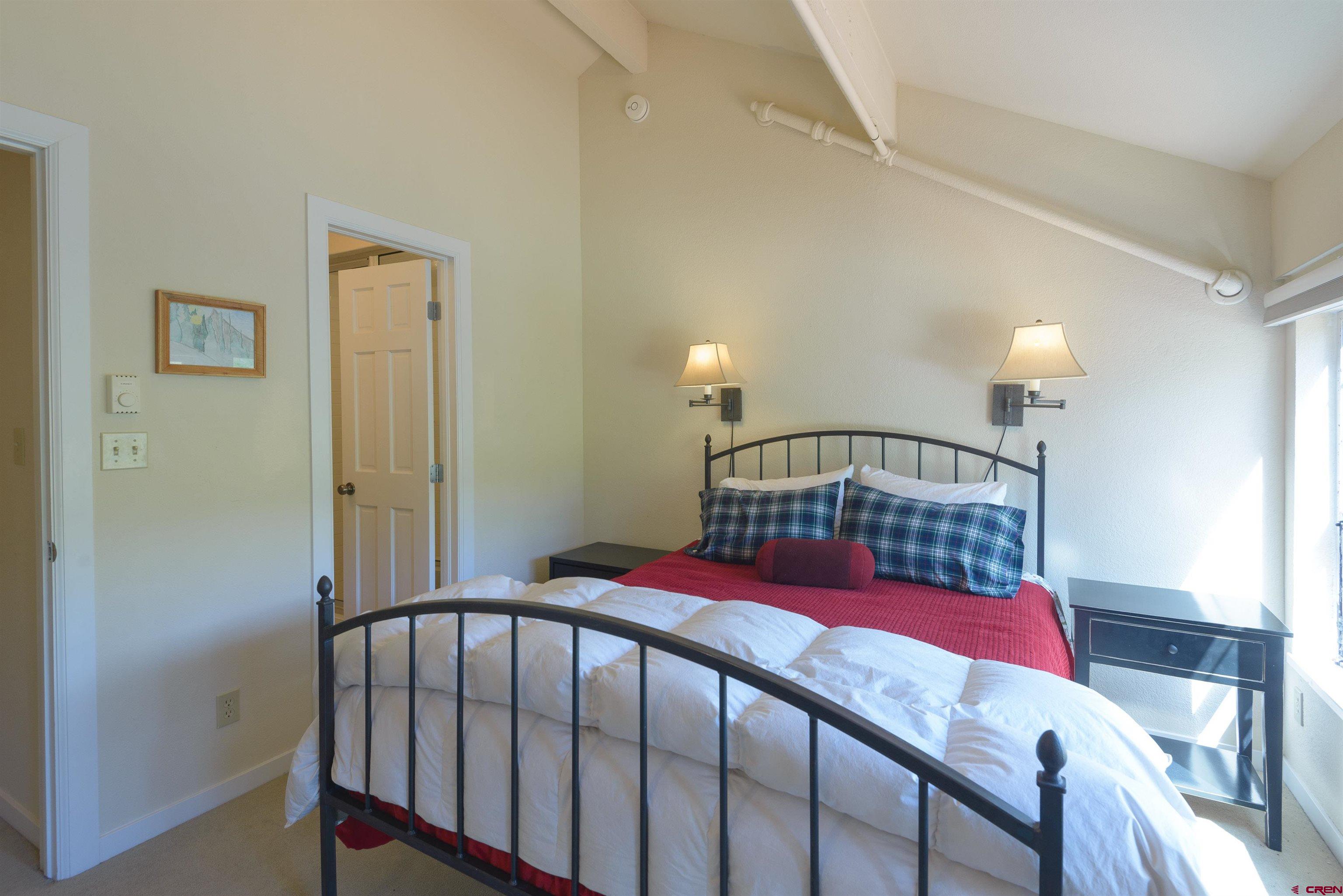 12 Snowmass Road, Unit 416 Crested Butte, CO 81225 - Photo 31 of 35 a bedroom with a bed and a window