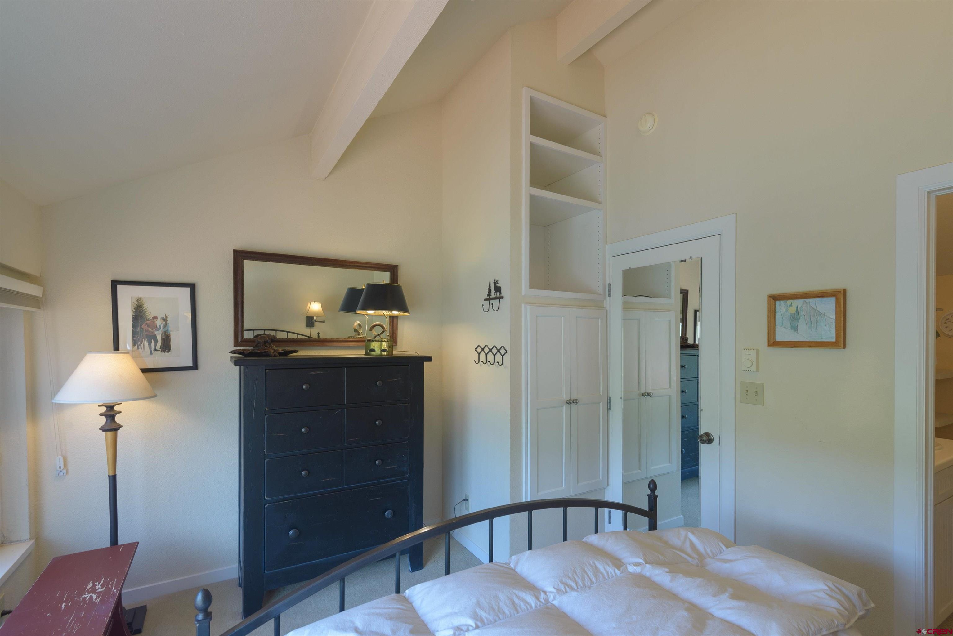 12 Snowmass Road, Unit 416 Crested Butte, CO 81225 - Photo 32 of 35 a bedroom with a bed and wooden floor
