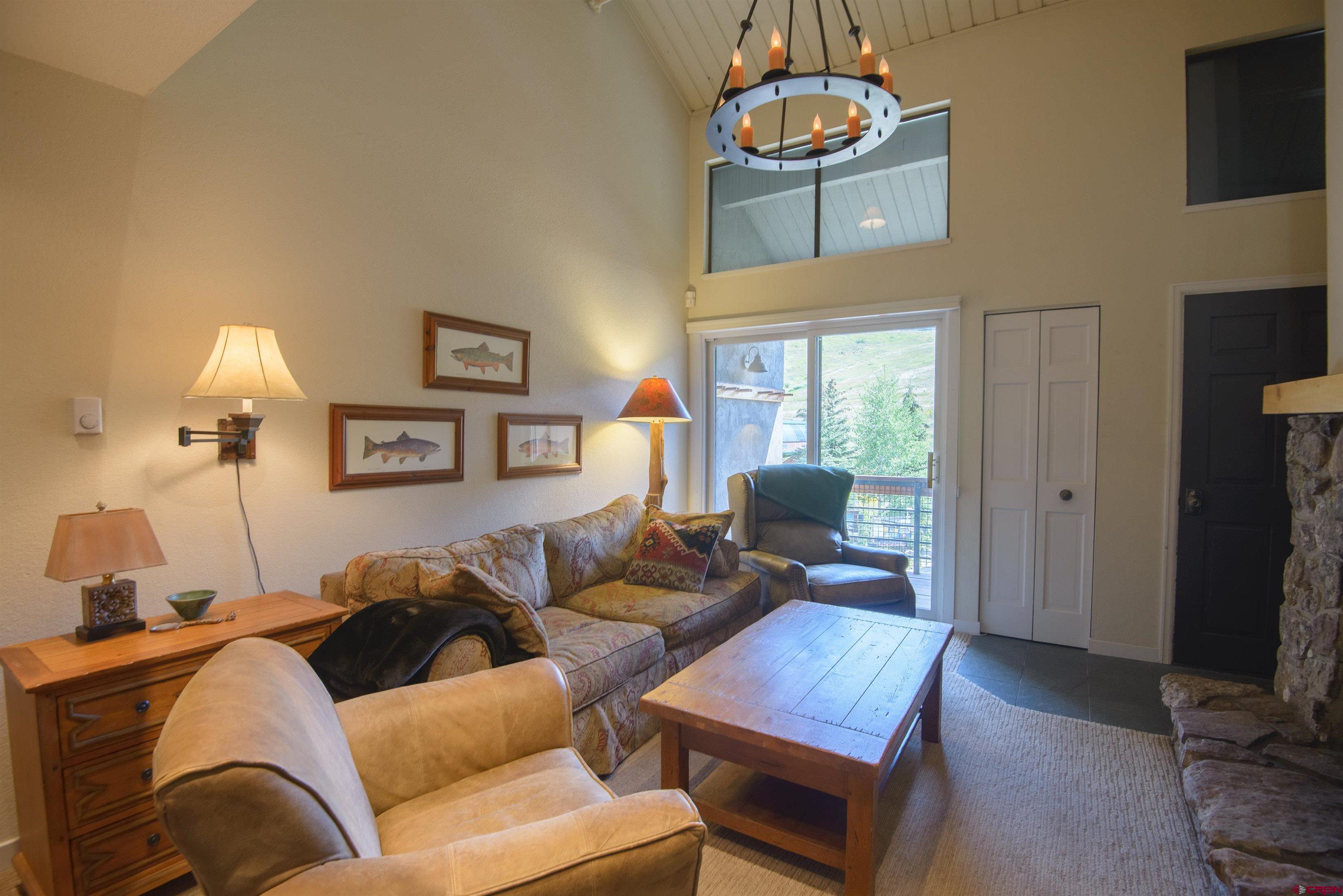 12 Snowmass Road, Unit 416 Crested Butte, CO 81225 - Photo 7 of 35 a living room with furniture and a flat screen tv