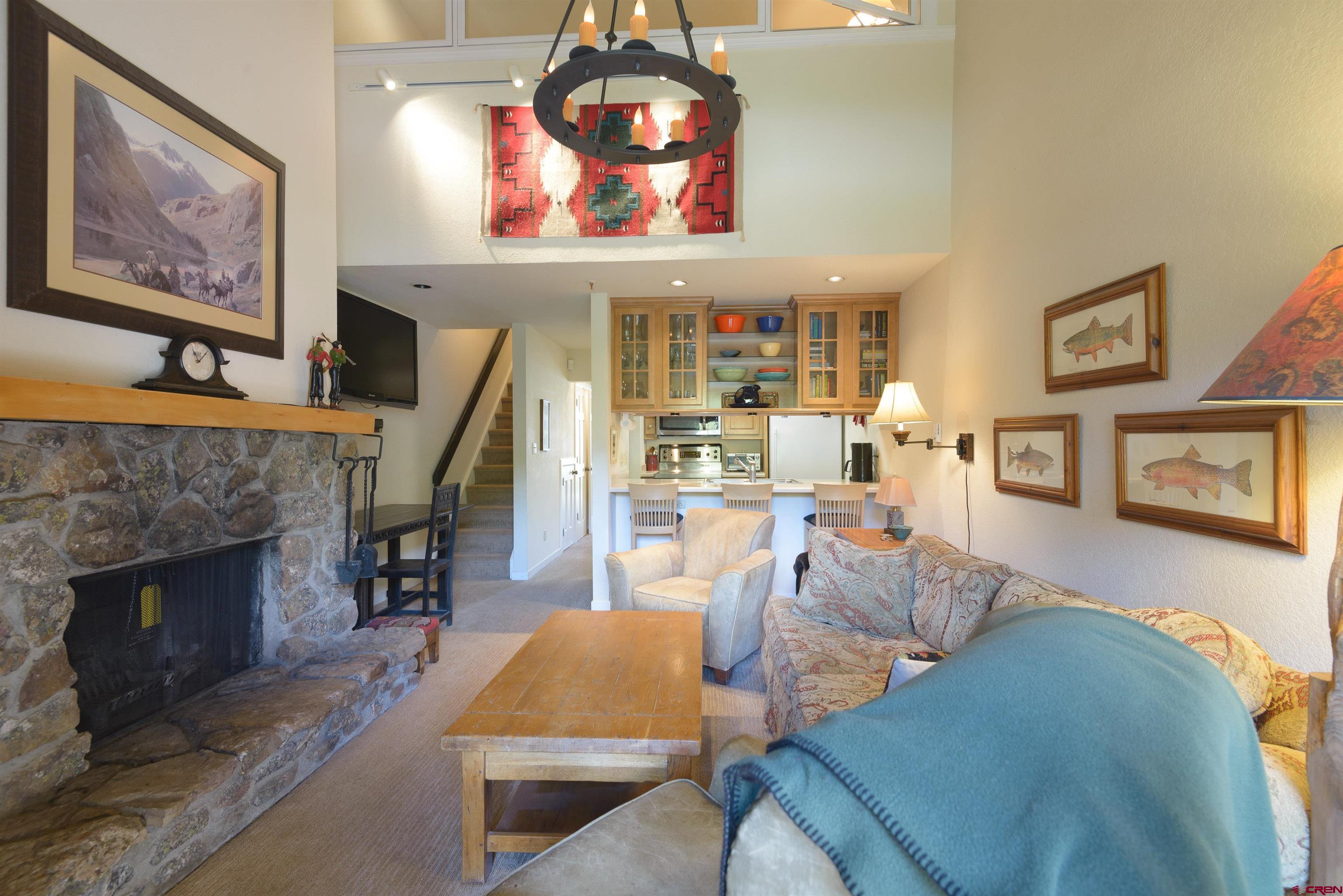 12 Snowmass Road, Unit 416 Crested Butte, CO 81225 - Photo 10 of 35 a living room with furniture and a fireplace