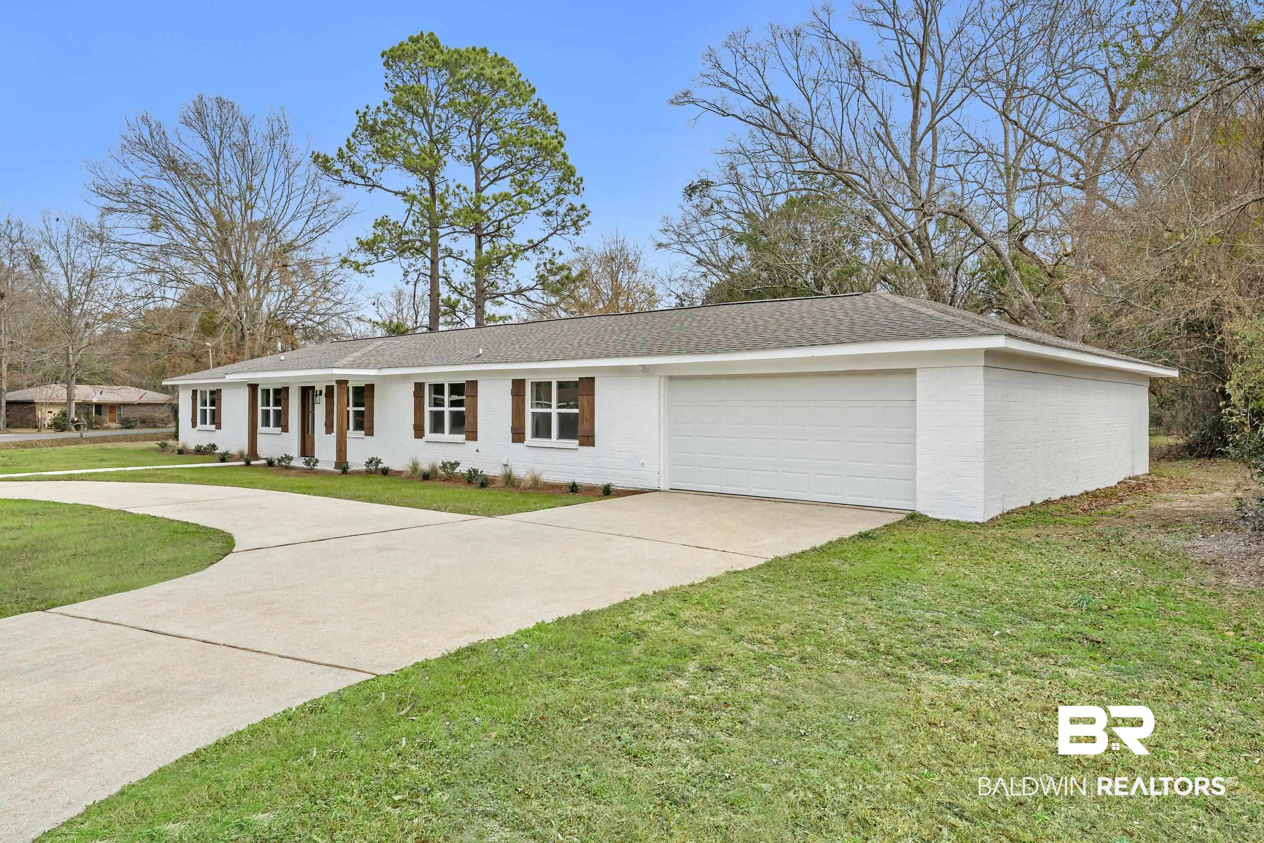 11381 Normandy Drive East Semmes, AL 36575 - Photo 3 of 23 Ranch-style home featuring brick siding, driveway, a front lawn, a garage, and roof with shingles