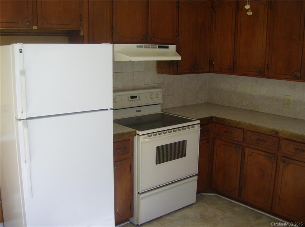 111 Fleetwood Road York, SC 29745 - Photo 9 of 23 a kitchen with a refrigerator and a stove