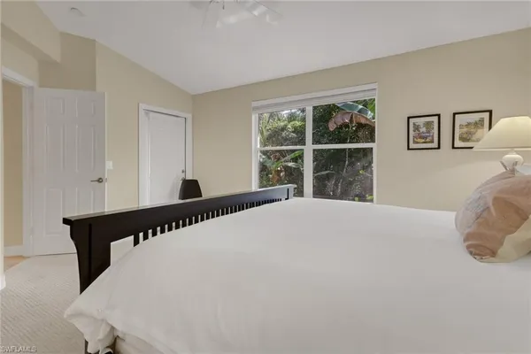 a bed sitting in a bedroom next to a window