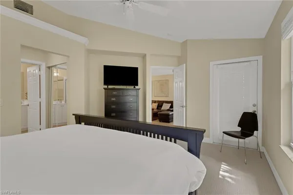 a bedroom with a bed and a television