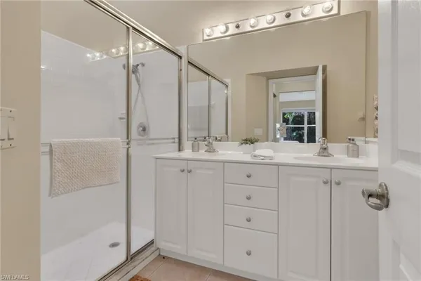 a bathroom with a shower sink and mirror