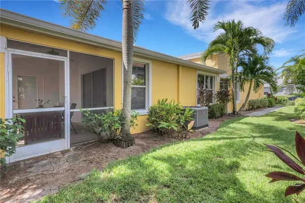 a view of a house with a yard and plants