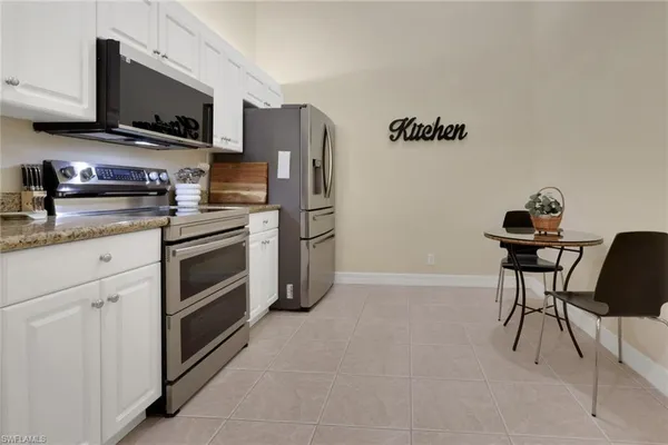 a kitchen with stainless steel appliances a stove microwave and a refrigerator