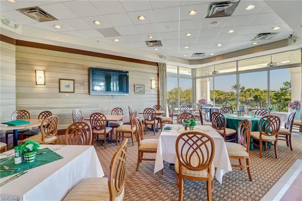 a very nice looking dining room with furniture window and outdoor view